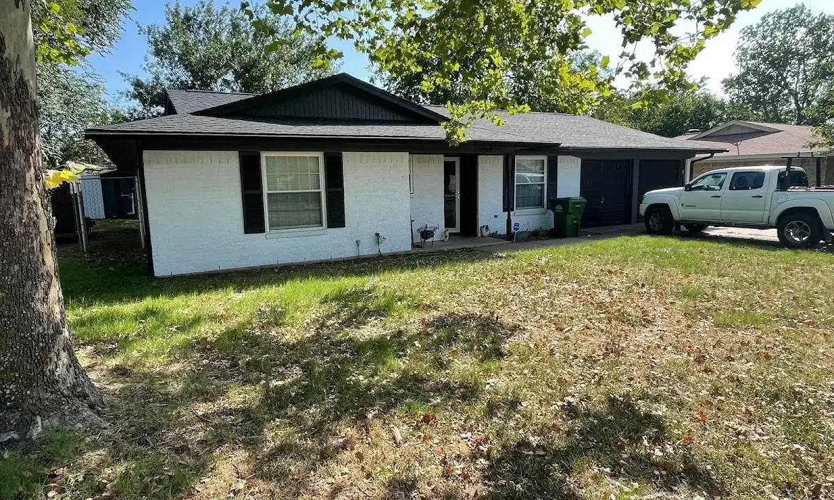 Professional roofing crew working on a residential roof in Monterey